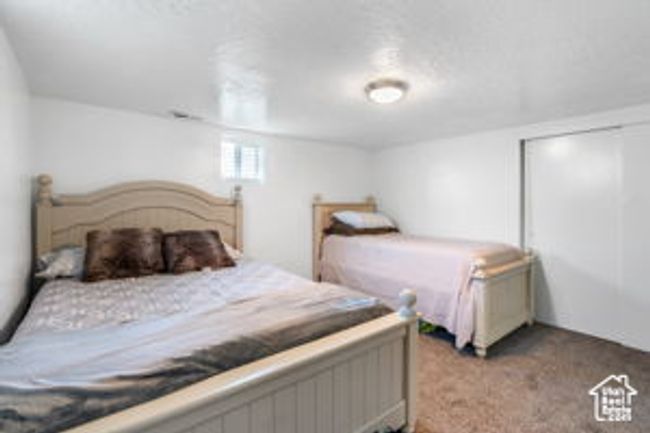 Carpeted bedroom with a closet | Image 22