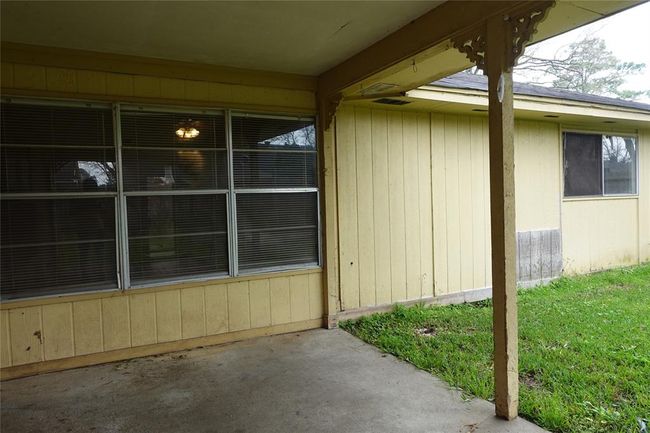 Enjoy the cozy covered patio with views from the living area. Exciting update: All siding has been replaced! | Image 25