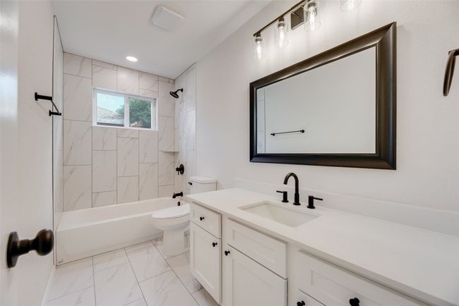 Full bath with toilet, vanity, marble finish floors, and shower / bathtub combination | Image 16