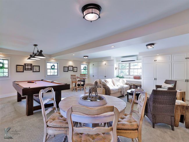 Dining room featuring a wall mounted AC, light carpet, healthy amount of natural light, billiards, and recessed lighting | Image 13