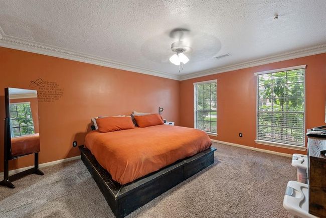 Wander through the living area to find the primary suite. | Image 18