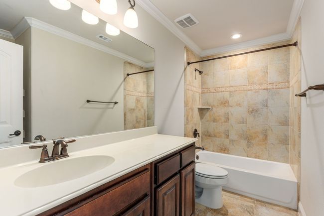 Full bath featuring visible vents, vanity, ornamental molding, and toilet | Image 35