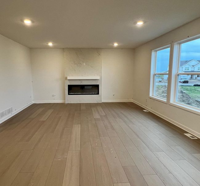 (Photo is of an inventory home, actual homes finishes will vary) Beautiful electric fireplace in the great room! | Image 5