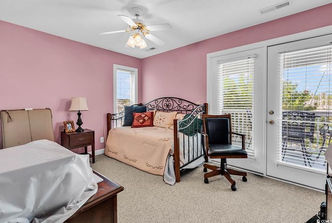 Carpeted bedroom featuring a ceiling fan, baseboards, access to outside, and visible vents | Image 24