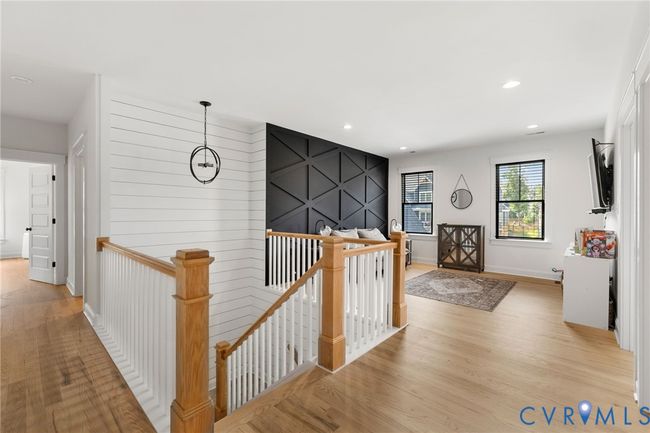 Hallway with an upstairs landing, light wood finished floors, and recessed lighting | Image 28