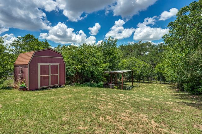 View of green lawn featuring a shed | Image 10