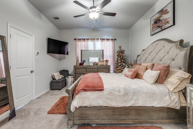Bedroom with carpet flooring, a ceiling fan, and baseboards | Image 11