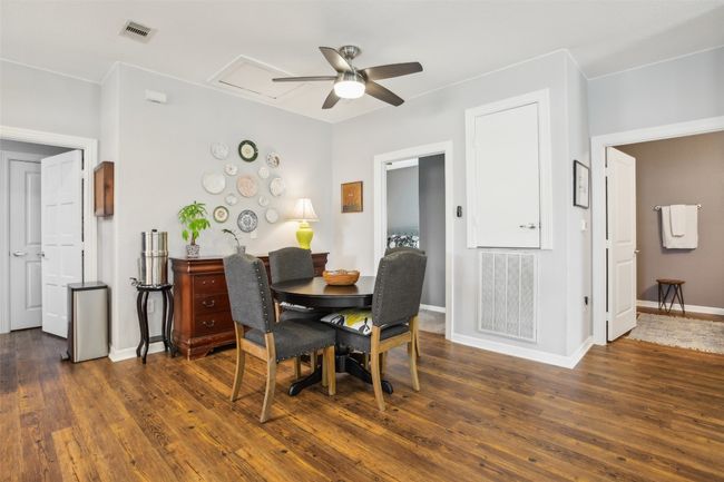 Dining room featuring baseboards, visible vents, wood plank laminate flooring, and a ceiling fan | Image 11