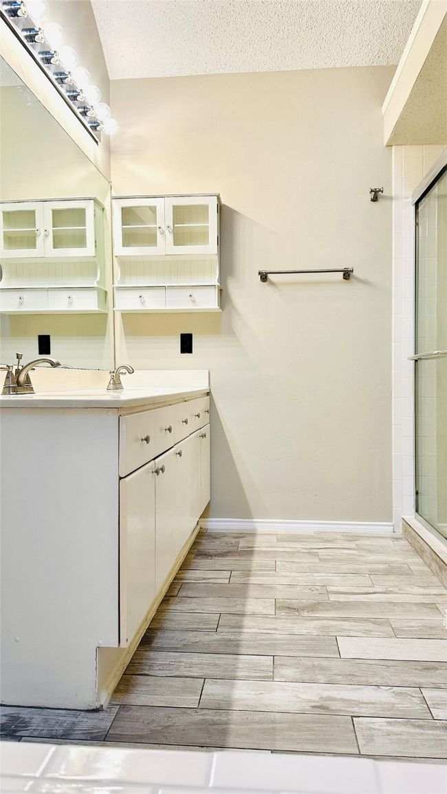 Full bathroom with vanity, a tile shower, and a textured ceiling | Image 4
