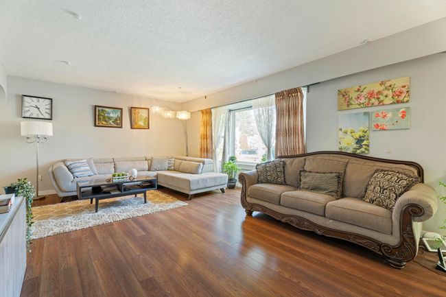 Living room featuring a textured ceiling and wood finished floors | Image 8