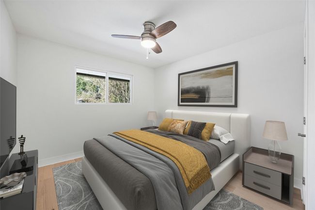 Bedroom with light wood-style floors and ceiling fan | Image 17