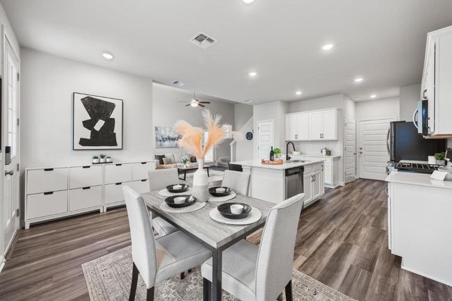 Dining room with dark wood-style floors, recessed lighting, and a ceiling fan | Image 6