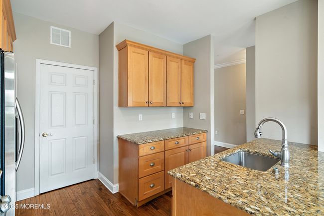 Kitchen area with a pantry | Image 13