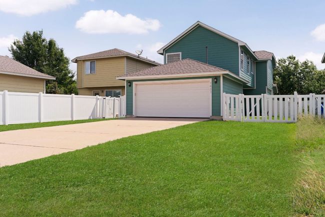 Featuring a two-car garage and an extended driveway that accommodates four more cars. | Image 30