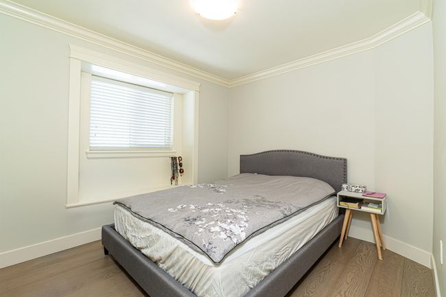 Bedroom featuring crown molding, baseboards, and wood finished floors | Image 14