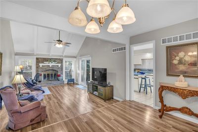 View of front of house featuring a balcony, a front yard, and a garage | Image 2