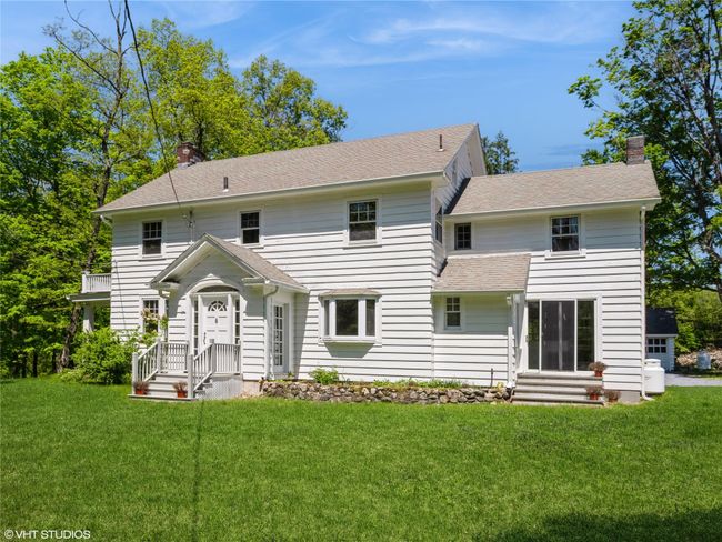 Back of property featuring a chimney, a lawn, and roof with shingles | Image 9