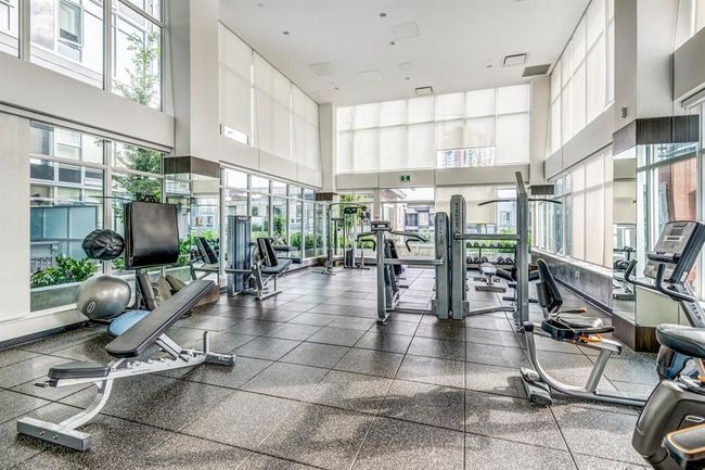 Workout area featuring a towering ceiling and healthy amount of natural light | Image 20
