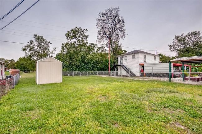 View of yard featuring a storage unit and an outbuilding | Image 25