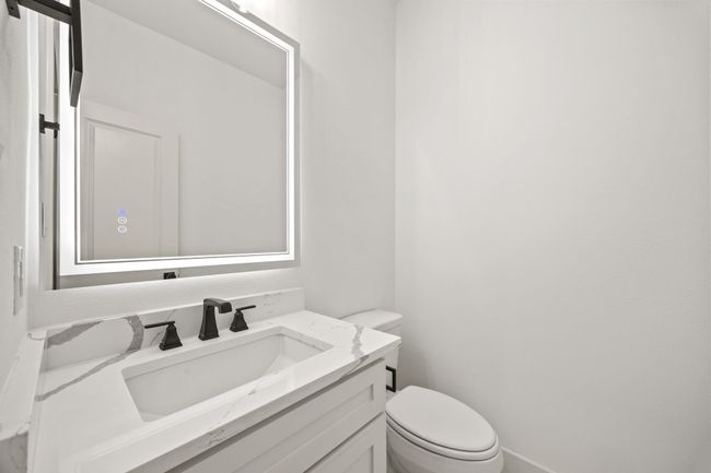 Bathroom featuring toilet, vanity, and baseboards | Image 27