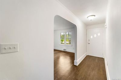 Entrance foyer featuring dark wood-type flooring and crown molding | Image 3