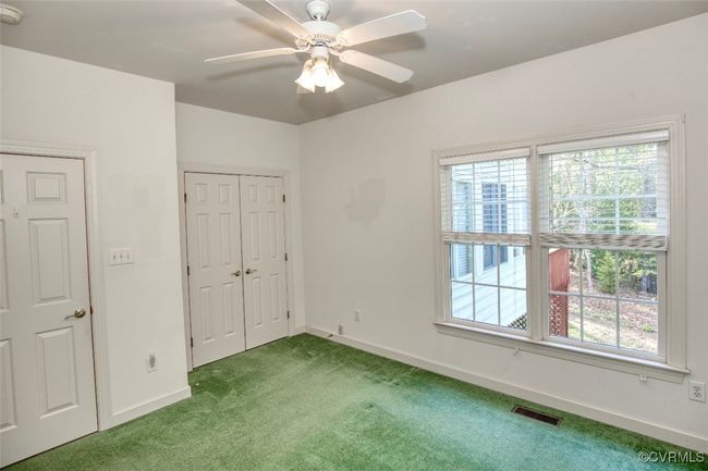 Unfurnished bedroom featuring a ceiling fan, a closet, carpet floors, baseboards, and visible vents | Image 28