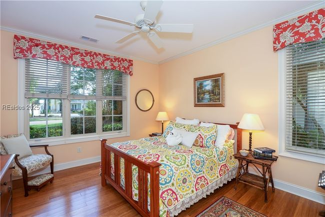 Bedroom 2 in the front of the home has an en-suite full bathroom for your guests. A Queen size bed is shown. | Image 30