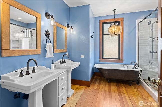 The upstairs bathroom is simply stunning, anchored by an original-style clawfoot tub that adds classic beauty and old-world charm. | Image 24