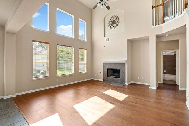 Spacious living room featuring a gas fireplace | Image 8
