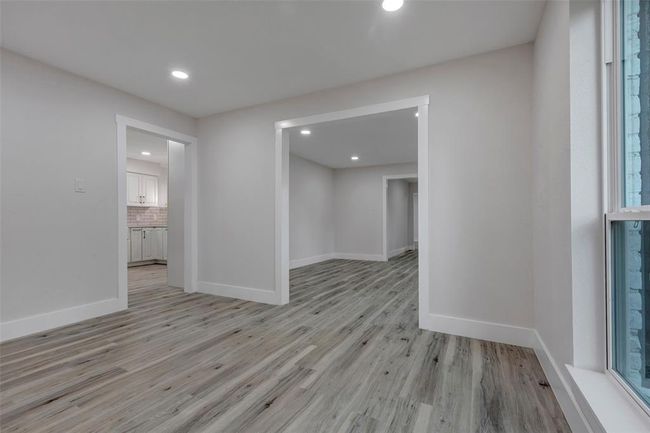 Formal dining room looking into the kitchen and family room/office/study. | Image 22