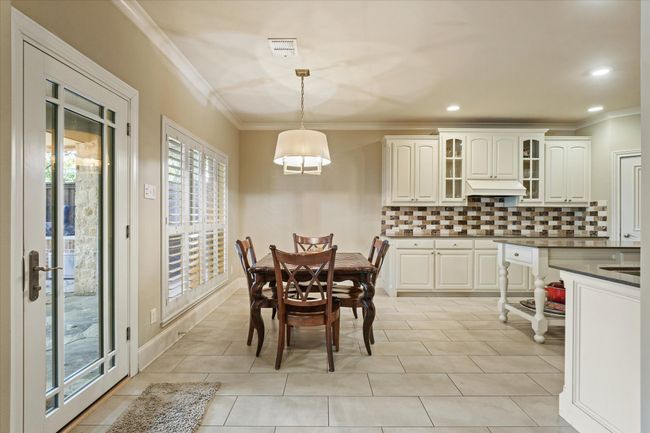Breakfast area featuring ornamental molding, light tile patterned floors, and recessed lighting | Image 13
