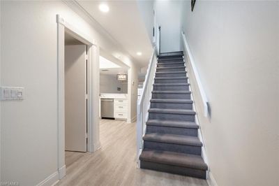 Stairway featuring ornamental molding and wood-type flooring | Image 3