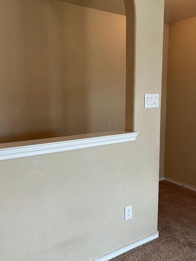 Hallway with carpet, baseboards, and arched walkways | Image 30