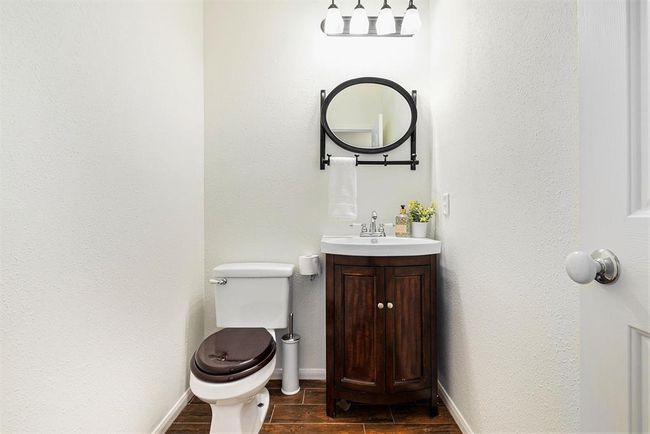 A quaint powder room stands ready for residents or guests to freshen up throughout the day! | Image 10