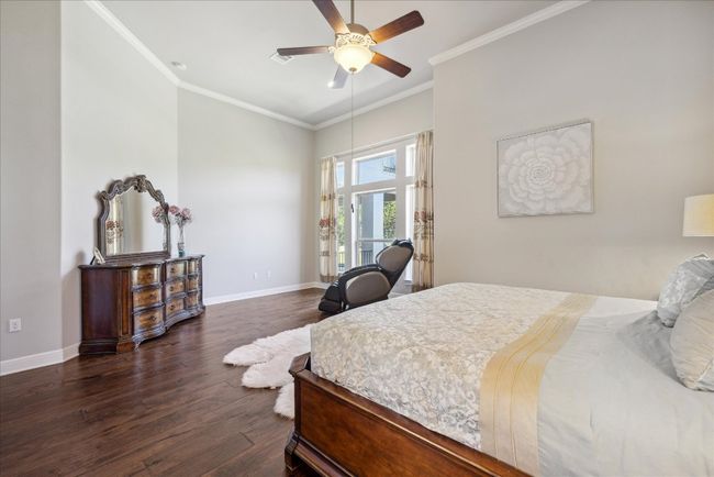 Bedroom featuring dark wood finished floors, baseboards, ceiling fan, and ornamental molding | Image 14