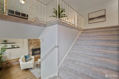 This split-level home is unique with its extra wide staircases leading up to the main level and down to the lower level. New carpet has been installed on the stairs and main level living spaces. | Image 3