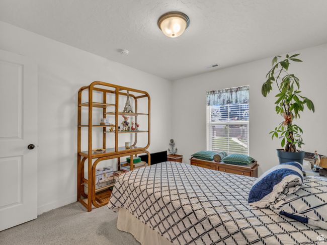Bedroom with carpet flooring and baseboards | Image 16