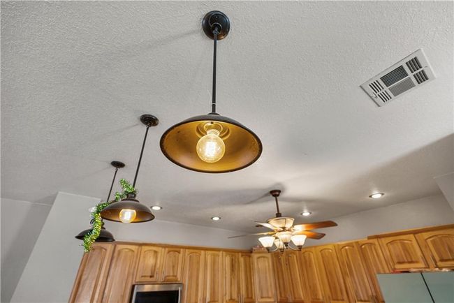 Interior details featuring ceiling fan and hanging light fixtures | Image 18