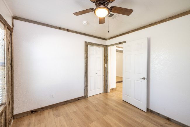 Unfurnished bedroom featuring visible vents, baseboards, light wood-type flooring, and a closet | Image 23