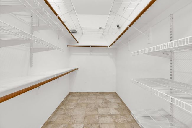 Walk in closet featuring stone finish floor | Image 32