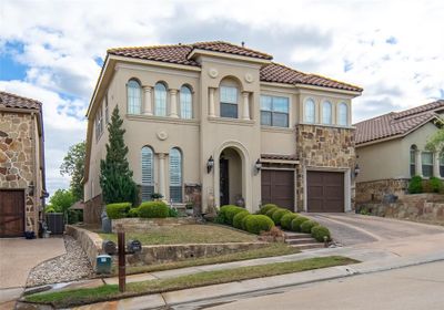 Mediterranean / spanish home featuring central AC and a garage | Image 1