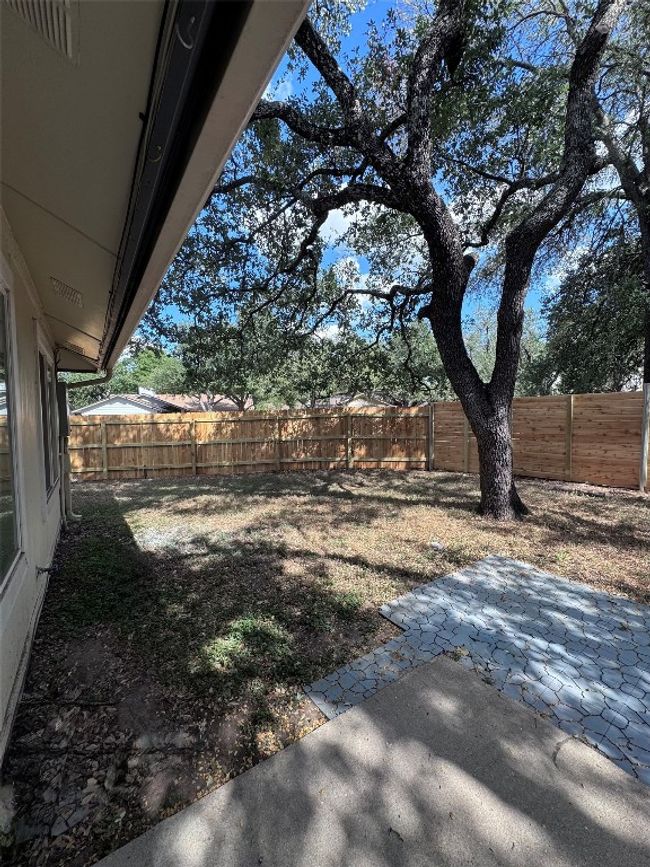 Fenced backyard with a patio | Image 27