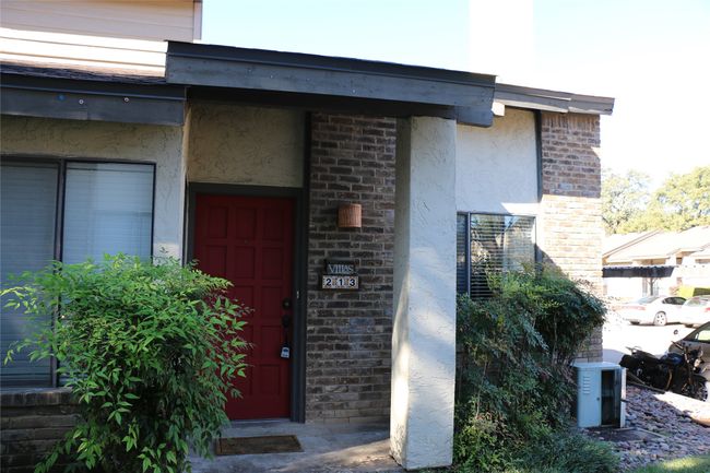 Doorway to property featuring stucco siding and brick siding | Image 4