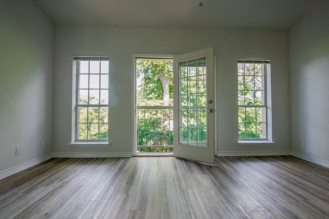 Spare room with wood finished floors and baseboards | Image 4