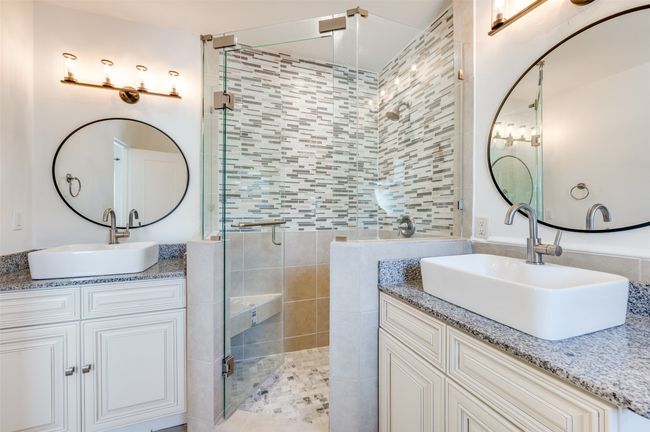 Full bath featuring a stall shower and two vanities | Image 30