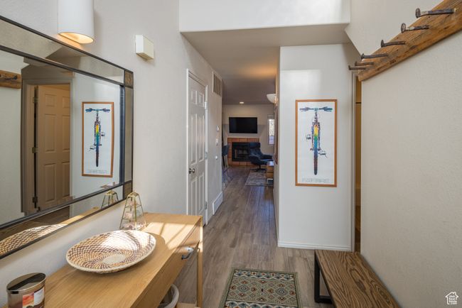 Interior space with hardwood / wood-style floors and a tiled fireplace | Image 9