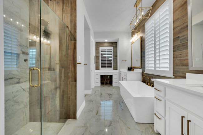 Full bathroom with vanity, a shower stall, a freestanding tub, and marble tiled flooring | Image 22