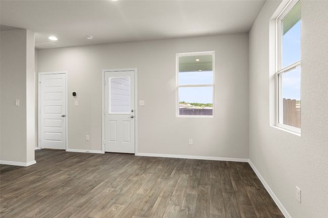 Spare room featuring dark wood-style floors and recessed lighting | Image 16