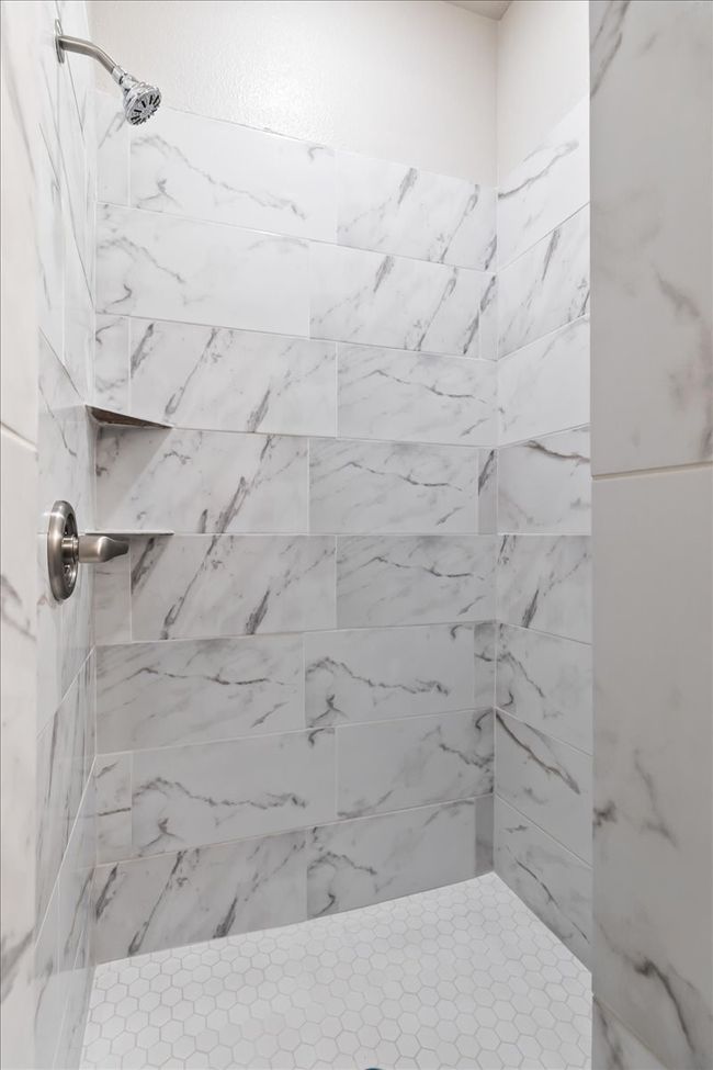 Bathroom featuring a tile shower | Image 16