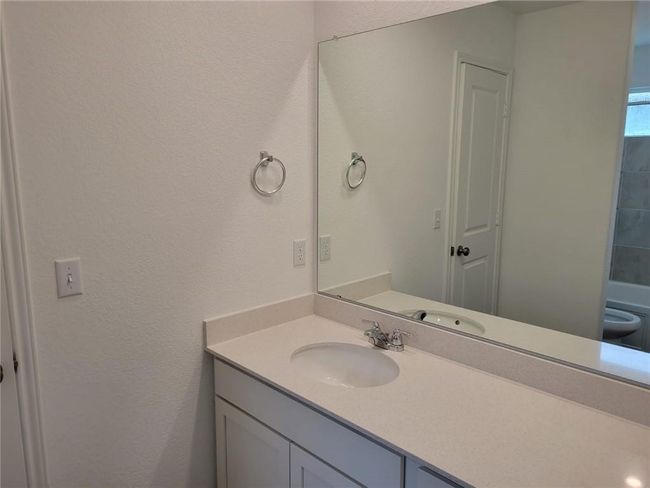 Bathroom with vanity and a textured wall | Image 29